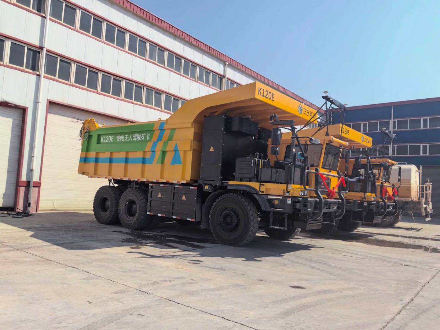 Hina Battery electric mining truck parked in an industrial yard.