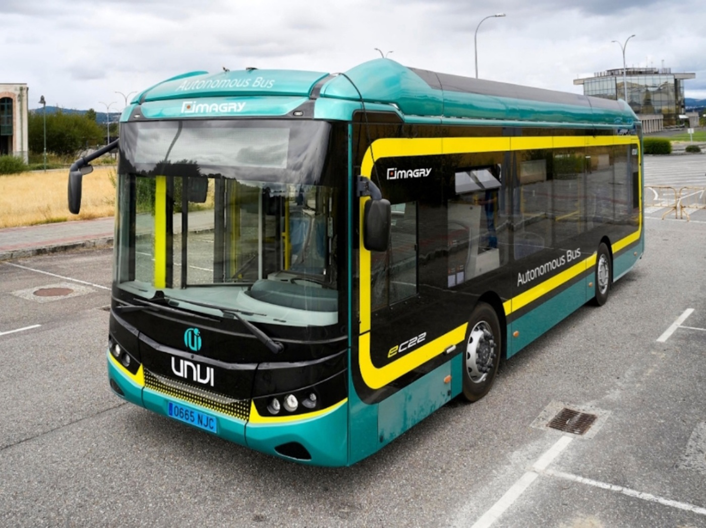 Imagry autonomous electric bus parked in an outdoor lot.