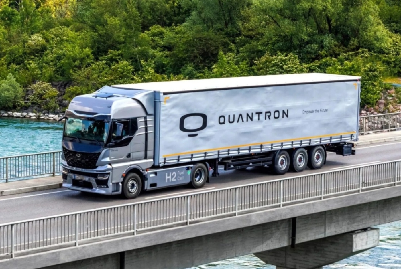 QUANTRON hydrogen-powered tractor truck drives across a bridge.